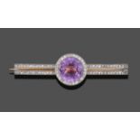 A Diamond and Pinkish-Purple Stone Bar Brooch, the round cut pinkish-purple stone within a border of