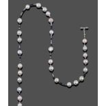 A Sapphire and Cultured Pearl Necklace, faceted sapphire beads of varying blue to white tones spaced