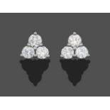 A Pair of 18 Carat White Gold Diamond Cluster Earrings, trios of round brilliant cut diamonds in