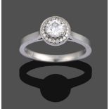 A Platinum Diamond Cluster Ring, the central round brilliant cut diamond in a four claw setting