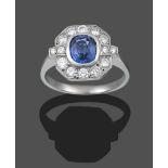 An Art Deco Style Sapphire and Diamond Cluster Ring, the cushion cut sapphire in a white