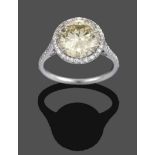 A Diamond Cluster Ring, a fancy intense yellow round brilliant cut diamond within a border of