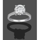 A Platinum Diamond Solitaire Ring, the round brilliant cut diamond in a white four claw setting,