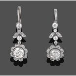 A Pair of Diamond Drop Earrings, four graduated old cut diamonds spaced by a diamond set floral