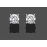 A Pair of Diamond Solitaire Stud Earrings, the round brilliant cut diamonds in white four claw