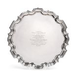 A George V Silver Salver, by Carrington and Co, London, 1922, shaped circular and on three pad feet,