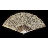 A White Mother-of-Pearl Fan, circa 1900, the monture carved and pierced,