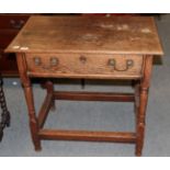 An 18th century oak side table, fitted with a drawer, raised on turned and block legs joined by