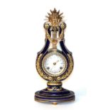 A 20th century French style porcelain 'Marie Antionette' style lyre-form timepiece