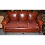 ^ A modern red leather three-seater sofa with studded decoration