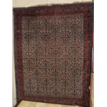 An Indo-Persian rug, the central field of meandering vines within conforming narrow borders,