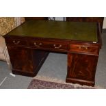 A reproduction mahogany desk with green leather writing surface, 145cm wide . Estimate £150-250