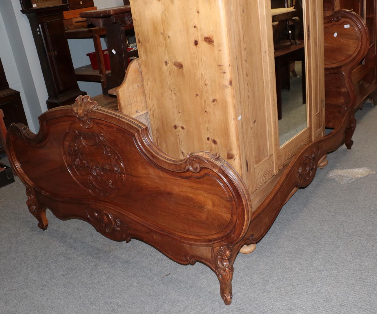 ^ A French carved hardwood double bedstead in the Louis XV style