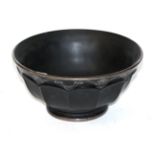 A silver inlaid black glass bowl,