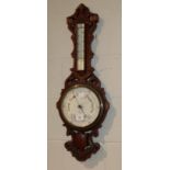 A late Victorian carved oak aneroid barometer, pottery dial signed Geo F. Brown & Co.