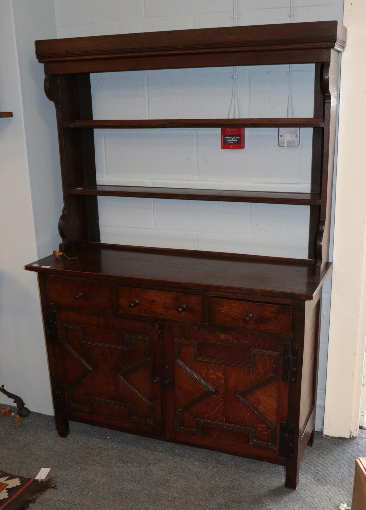 An 18th century oak dresser, the rack with two fixed shelves, the base with three drawers above