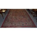 An Indo-Persian rug, the central field of mounted huntsman, trees, animals and birds,