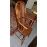 A Windsor chair, spindle back with pierced splat, on turned legs