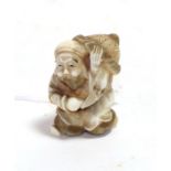 A Japanese ivory netsuke, Meiji period, as Jurojin carrying a large hat and a peach, signed,