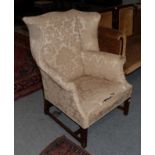 A George III mahogany framed wingback armchair