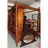 ^ A reproduction mahogany four poster bed, the four boldly turned uprights, surmounted by turned