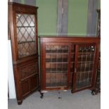 A 1930's leaded glazed oak bookcase, 120cm by 36cm by 129cm high; together with a reproduction