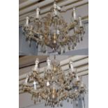 ^ A pair of Venetian style lustre drop ten-light chandeliers