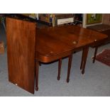 A George III string inlaid mahogany D-end dining table, raised on tapering square section legs and
