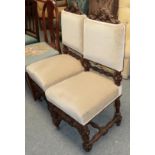 A pair of Victorian carved oak chairs with upholstered seats