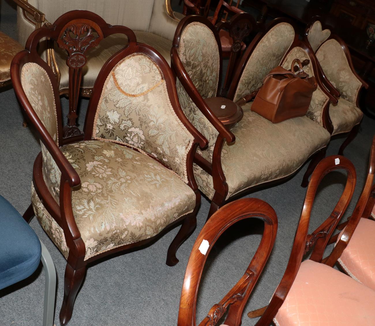 A three piece mahogany framed salon suite comprising a sofa and two chairs