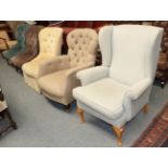 ^ A group of upholstered chairs comprising a wing back, four button backs, and two open arm tub