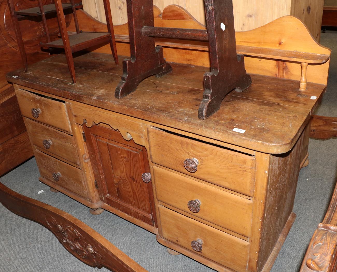 A Victorian pine sideboard with six drawers around a cupboard door, 160cm wide