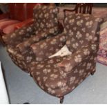 A pair of mahogany framed armchairs upholstered in brown floral fabric