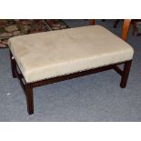 A modern cream upholstered oversized foot stool, on mahogany frame with twin supporting stretchers,
