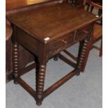 A 17th century style oak side table with two small drawers and turned legs, 76cm by 47cm by 77cm