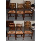 A set of six (4 + 2) rush seated ladder back chairs probably Titchmarsh & Goodwin