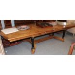 A mid 20th century American extending dining table, the extending top raised on six parcel gilt