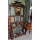 ^ A Victorian carved oak mirrored hall stand, together with a bedside cupboard (a.f.), 92cm by