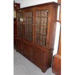 A 20th century leaded and glazed three door oak bookcase, 185cm high by 171cm wide by 39cm deep