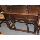 A 17th century style oak side table, fitted with a drawer and raised on tapering cylindrical