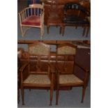 A pair of early 20th century carved oak hall chairs in the Arts & Crafts taste,