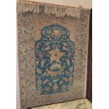 An Oriental prayer rug, the Mihrab decorated with stylised flowers on a blue ground,