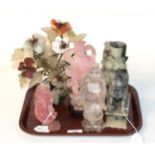 A Chinese rock crystal figure of an immortal, standing holding a branch over his shoulder,