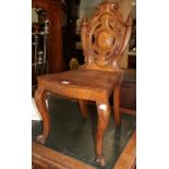 A 19th century carved oak shield back chair