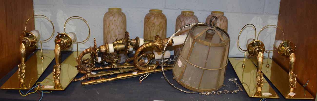 ^ A set of four gilt metal scroll cast single wall lights with brass back plates and marble glass