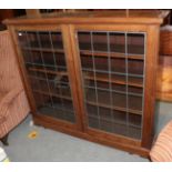 A mahogany leaded and glazed bookcase with adjustable shelves, 123cm H by 142cm W by 26cm D