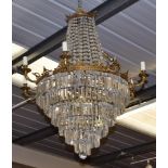 ^ An impressive gilt metal, lustre drop nineteen-light chandelier