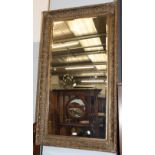 ^ A large rectangular gilt framed mirror, the bevelled plate within a conforming frame moulded