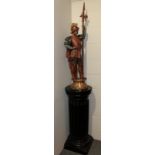 A painted spelter figure of a Continental soldier with dragon surmounted helmet and halberd,