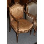 A French Louis XVI style gilt framed open armchair with floral embroidered gold silk upholstery